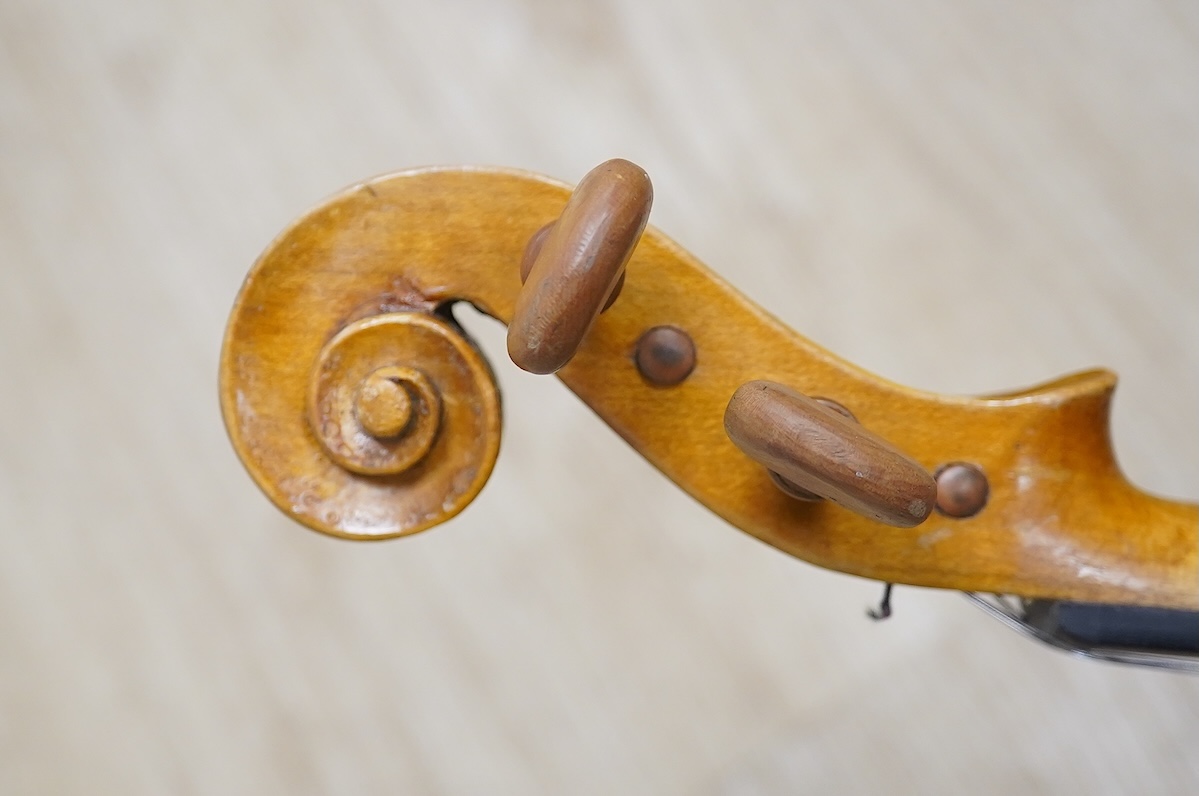 Two cased three quarter size violins, one labelled the London violin Co Ltd, length of back 33.5cm. Condition - both scratched